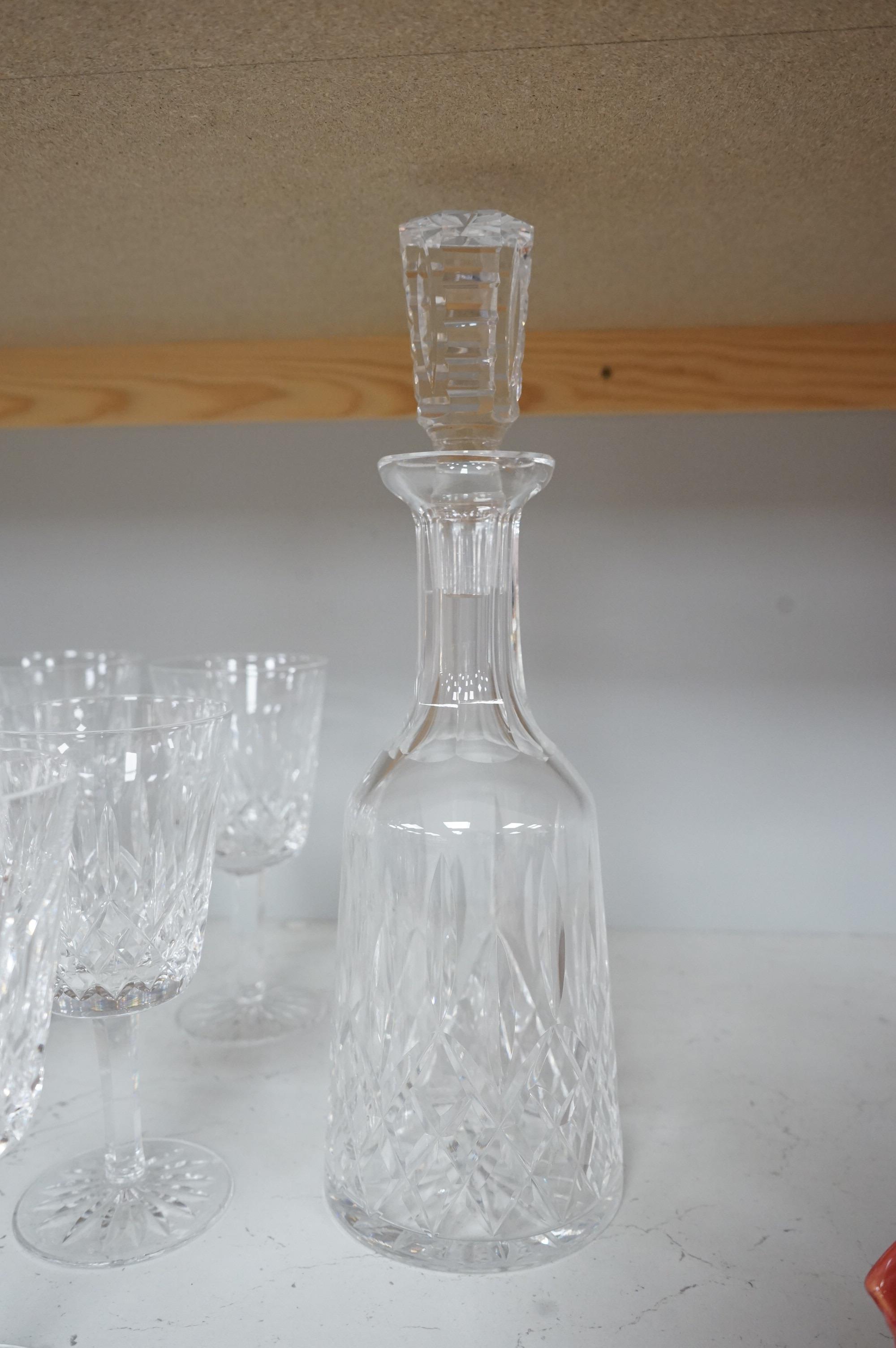 Twenty two Waterford Crystal company wine glasses and a decanter, 33cm